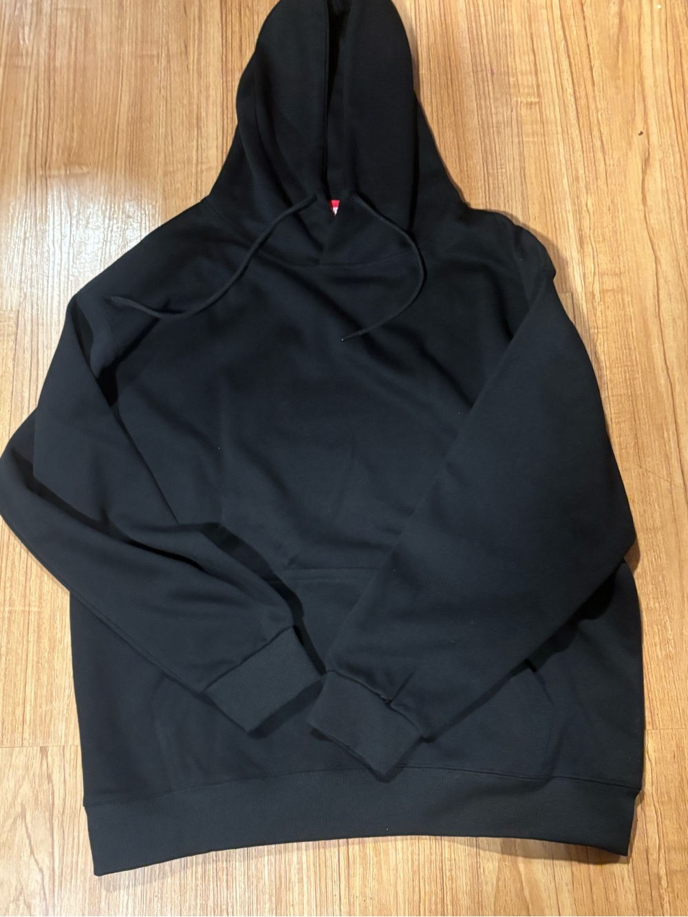 Supreme Black Pullover Hoodie with Subtle Red Tag